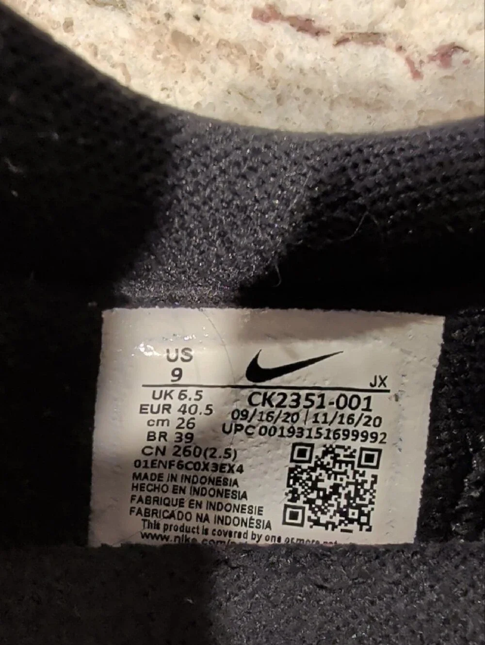 Nike Black Sneakers with White Swoosh and Orange Tongue Logo
